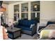 Inviting covered patio with outdoor seating, grill, and a view of the home's architecture at 2159 Holland Creek Ln, Buford, GA 30519
