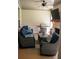 Cozy screened-in patio featuring comfortable seating, brick fireplace, and a grill at 2159 Holland Creek Ln, Buford, GA 30519