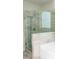 Modern shower featuring glass enclosure, tiled walls, and rainfall showerhead at 2159 Holland Creek Ln, Buford, GA 30519