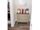 Neutral foyer with storage in cabinet with three drawers and a scale and books on top at 2159 Holland Creek Ln, Buford, GA 30519