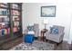 Study has reading nook with bookcase and chairs, and a patterned rug at 2159 Holland Creek Ln, Buford, GA 30519