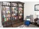 Study with a dark wood bookcase, ladder, patterned rug, and chairs for reading at 2159 Holland Creek Ln, Buford, GA 30519