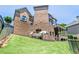 Brick home featuring multiple decks with a well-maintained lawn and landscaping at 3487 Binghurst Rd, Suwanee, GA 30024