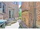 Charming backyard patio features brick fireplace, stone accents, and access through elegant French doors at 3487 Binghurst Rd, Suwanee, GA 30024