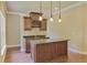 This bar features wooden cabinets, granite countertops, and pendant lights at 3487 Binghurst Rd, Suwanee, GA 30024