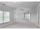 Spacious bedroom with neutral carpet, tray ceiling with fan, and abundant natural light at 3487 Binghurst Rd, Suwanee, GA 30024
