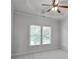 Neutral bedroom featuring a ceiling fan, carpeted flooring, and window with natural light at 3487 Binghurst Rd, Suwanee, GA 30024