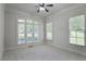 Bright bedroom featuring neutral carpet, large windows, and ample natural light at 3487 Binghurst Rd, Suwanee, GA 30024