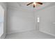Neutral bedroom featuring a ceiling fan, carpeted flooring, and window with natural light at 3487 Binghurst Rd, Suwanee, GA 30024