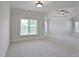 Spacious bedroom with neutral carpet, tray ceiling with fan, and multiple bright windows at 3487 Binghurst Rd, Suwanee, GA 30024