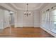 Dining area with wood floors, wainscoting, and a chandelier at 3487 Binghurst Rd, Suwanee, GA 30024