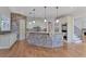 Spacious kitchen features a large stone island, stainless steel appliances, and custom cabinetry at 3487 Binghurst Rd, Suwanee, GA 30024