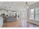 Open-concept kitchen boasts a stone-clad island, stainless steel appliances, and bright windows at 3487 Binghurst Rd, Suwanee, GA 30024