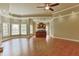 Open floor plan with wood floors, bar, tray ceiling, ceiling fan, and abundance of natural light at 3487 Binghurst Rd, Suwanee, GA 30024
