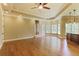 Open floor plan featuring wood floors, bar, trey ceiling, ceiling fan, and an abundance of natural light at 3487 Binghurst Rd, Suwanee, GA 30024