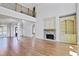 Large open-concept space with hardwood floors, fireplace, and a second-story overlook at 3487 Binghurst Rd, Suwanee, GA 30024