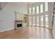 Spacious living area boasting hardwood floors, stone fireplace, and abundant natural light at 3487 Binghurst Rd, Suwanee, GA 30024