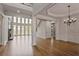 Bright open-concept living area with hardwood floors, large windows, and a stone fireplace at 3487 Binghurst Rd, Suwanee, GA 30024