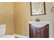 Charming powder room boasts classic fixtures, a pedestal sink and a decorative mirror at 3487 Binghurst Rd, Suwanee, GA 30024