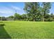Spacious backyard with large trees and view of house in the distance at 3551 Clay Rd, Austell, GA 30106