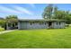 Charming single-story home featuring a covered carport, gray brick facade, and a lush green front lawn at 3551 Clay Rd, Austell, GA 30106