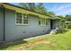 Exterior view of house with light blue paint, greenery, and multiple windows at 3551 Clay Rd, Austell, GA 30106