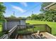 View of backyard and detached garage with wood deck in the foreground at 3551 Clay Rd, Austell, GA 30106