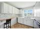 Kitchen with white cabinets, counter space, natural light, and dining area with bar stool at 3551 Clay Rd, Austell, GA 30106
