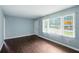 Inviting living room showcasing hardwood floors, natural light from a large window, and a neutral color scheme at 3551 Clay Rd, Austell, GA 30106