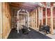 Unfinished basement with exposed wood framing and gym equipment at 6065 Ashbury Ln, Cumming, GA 30028