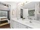 Bathroom with double sinks, a large mirror, and view of the bedroom at 6065 Ashbury Ln, Cumming, GA 30028