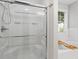 Modern bathroom featuring a glass-enclosed shower, soaking tub, and natural light from the window at 6065 Ashbury Ln, Cumming, GA 30028