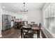 Bright dining area with stainless appliances, white cabinets and a modern chandelier; with table for Gathering meals at 6065 Ashbury Ln, Cumming, GA 30028