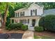 Charming two-story home boasts a well-manicured lawn, lush landscaping, and a welcoming front porch at 6065 Ashbury Ln, Cumming, GA 30028