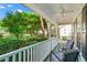 Relax on this covered front porch with comfortable seating, offering serene views of the lush, green surroundings at 6065 Ashbury Ln, Cumming, GA 30028