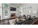 Bright living room with high ceilings, fireplace, large windows, dark floors, and modern furnishings at 6065 Ashbury Ln, Cumming, GA 30028
