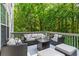 Outdoor living space on a deck with comfortable seating and a view of the trees at 6065 Ashbury Ln, Cumming, GA 30028