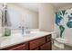 Cozy bathroom featuring white vanity top, globe shower curtain and earth-tone tile floor at 161 Brasch Park Dr, Grantville, GA 30220