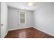 Spare bedroom featuring gray walls, hardwood floors, and a large window at 161 Brasch Park Dr, Grantville, GA 30220