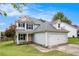 Charming two-story home with a two-car garage and manicured lawn at 161 Brasch Park Dr, Grantville, GA 30220