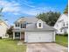 Charming two-story home with a two-car garage and manicured lawn at 161 Brasch Park Dr, Grantville, GA 30220
