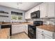 Modern kitchen featuring updated appliances, countertops and a view through the window at 161 Brasch Park Dr, Grantville, GA 30220