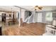 Open living room into kitchen area with fireplace, ceiling fan, and neutral decor at 161 Brasch Park Dr, Grantville, GA 30220