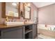 Main bathroom features double sinks, updated cabinets and a soaking tub at 161 Brasch Park Dr, Grantville, GA 30220