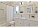 Bright bathroom with double sinks, white marble counters and a shower with a white curtain at 2125 Clay Rd, Austell, GA 30106