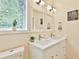 Stylish bathroom featuring dual sinks, framed mirrors and decorative light fixtures at 2125 Clay Rd, Austell, GA 30106