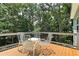 Inviting deck features metal chairs and table, surrounded by a lush green treetop view at 2125 Clay Rd, Austell, GA 30106