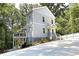 Charming three-story home with modern siding, front porch, and deck surrounded by lush greenery at 2125 Clay Rd, Austell, GA 30106