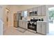 Modern kitchen with stainless steel appliances, stylish countertops, and grey cabinetry at 2125 Clay Rd, Austell, GA 30106