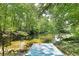 Scenic pond view with wooden dock surrounded by lush trees for tranquil outdoor retreat at 2125 Clay Rd, Austell, GA 30106